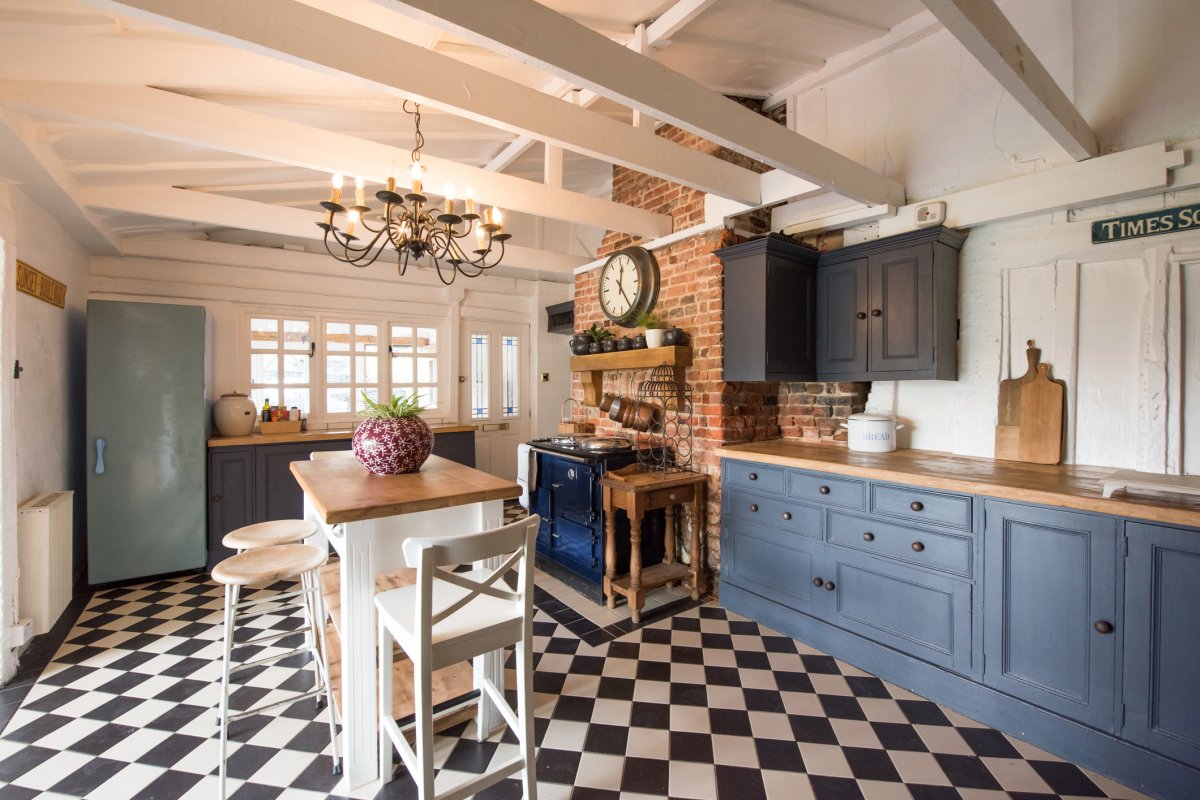 Kitchen with black and white checkerboard tile floor.