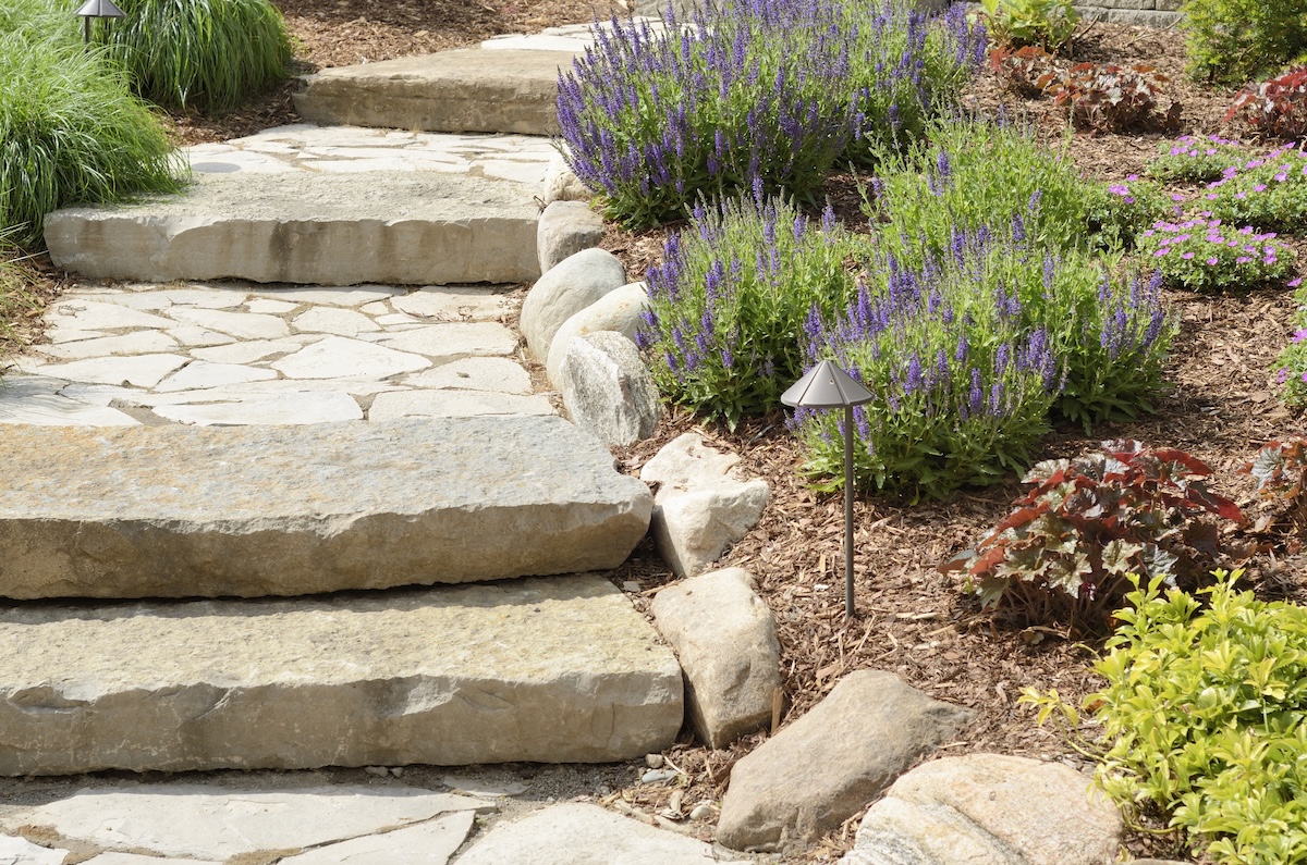 A DIY garden path with large stone stairs.