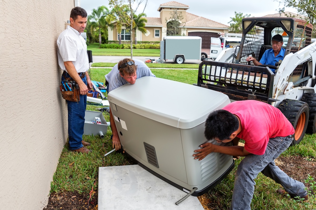 Technicians installing a home generator.