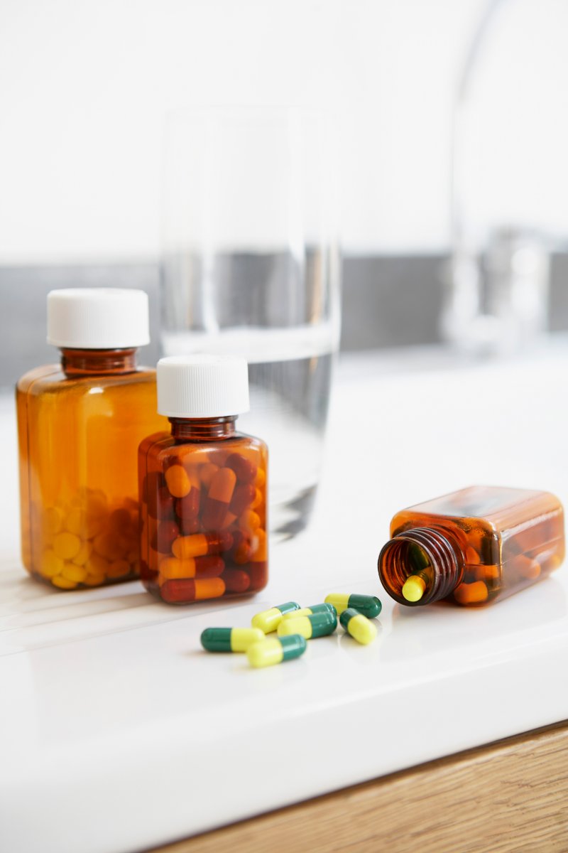 Spilt bottle of pills on counter in bathroom.