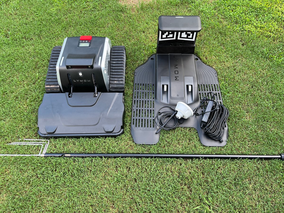 Setting up Lymow One robot mower and its dock in the backyard
