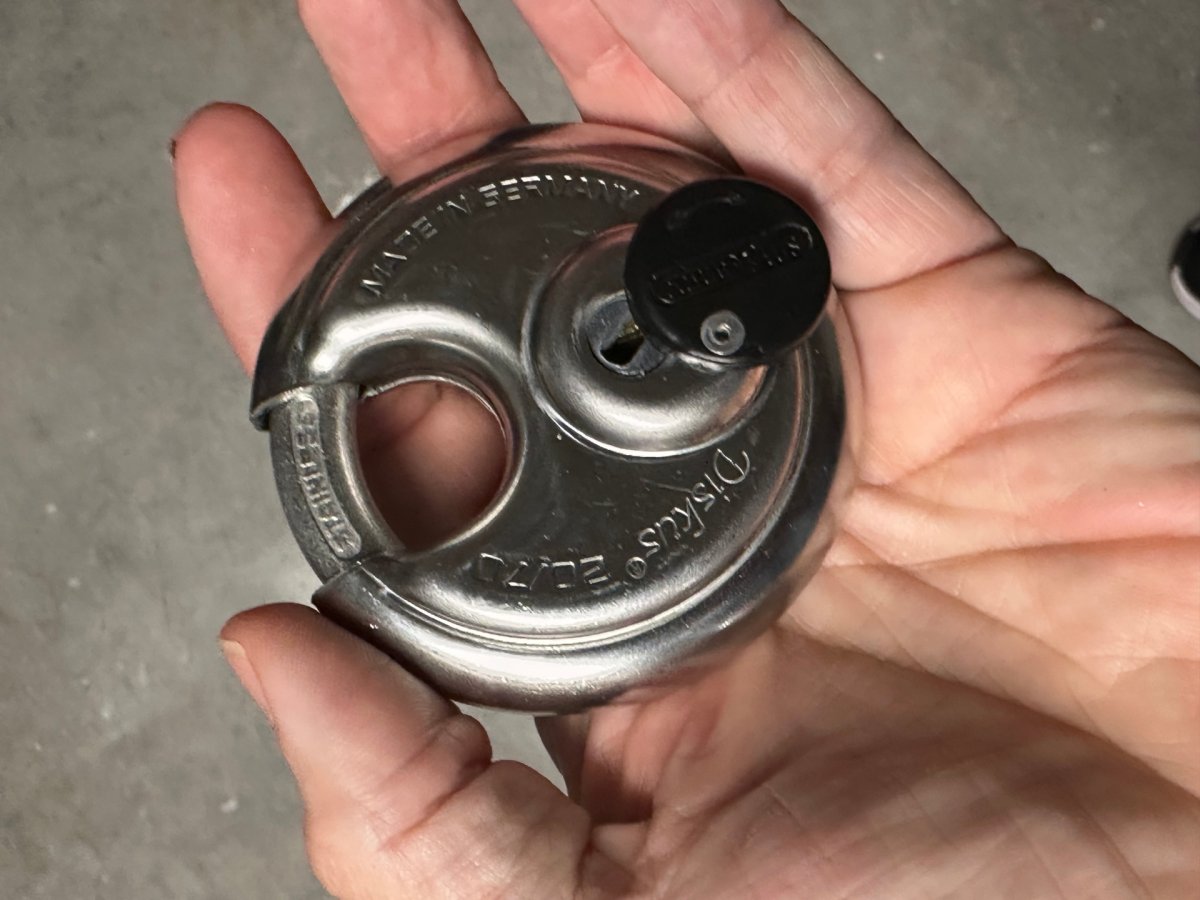 A person holding a padlock in a hand
