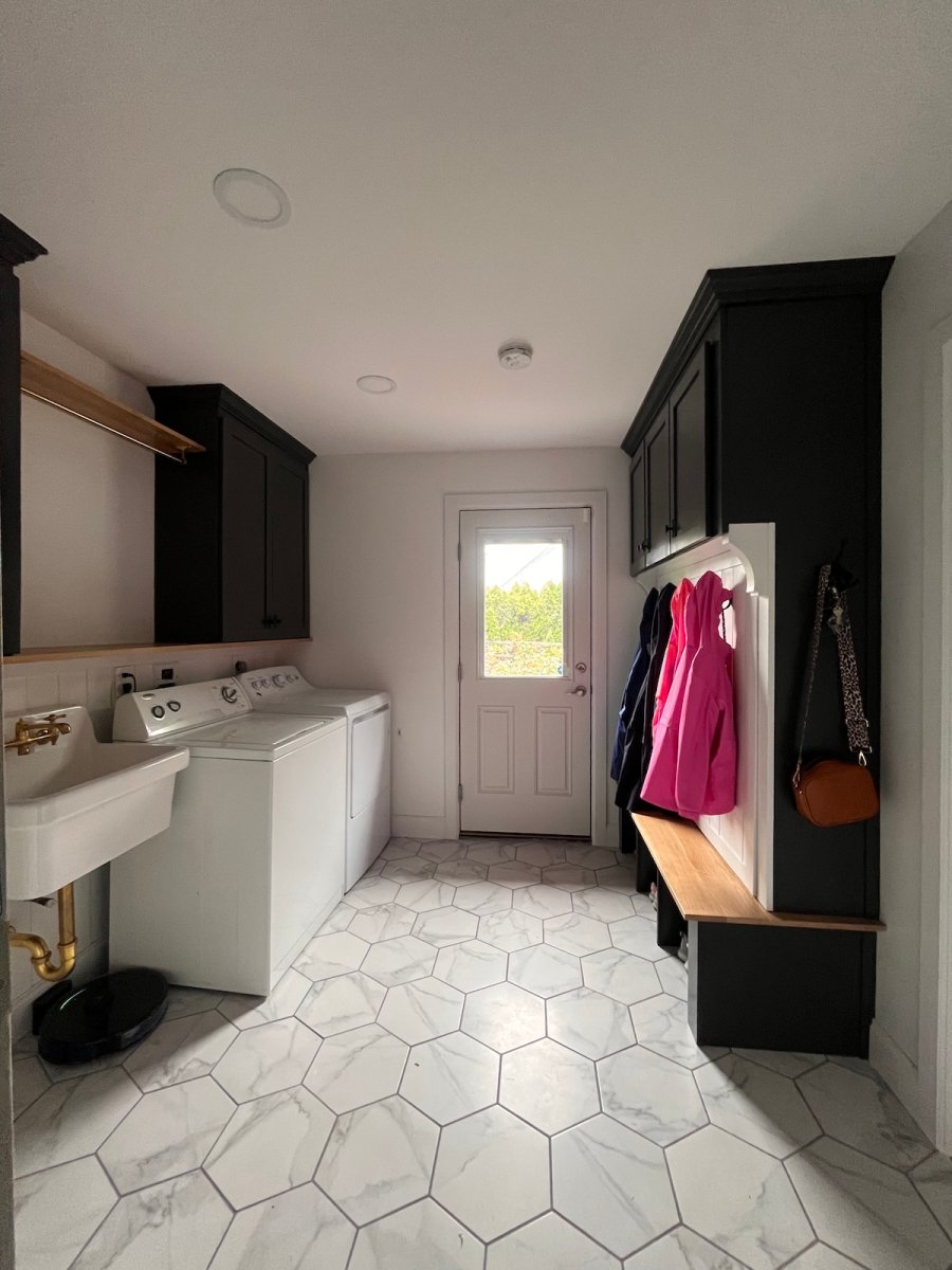 An "after" shot of a hidden storage mudroom unit in a laundry room.