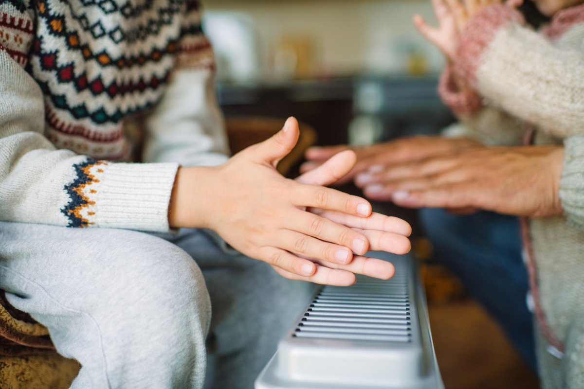 Family warming hands at home over a space heater