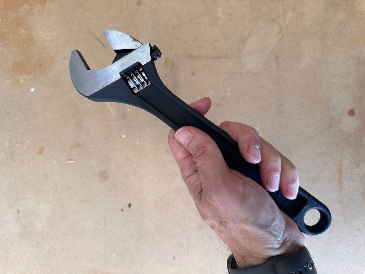 Hand holding Crescent adjustable wrench