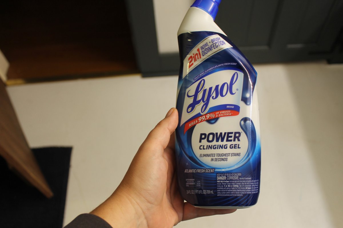Hand holding bottle of Lysol Power Cling Toilet bowl cleaner