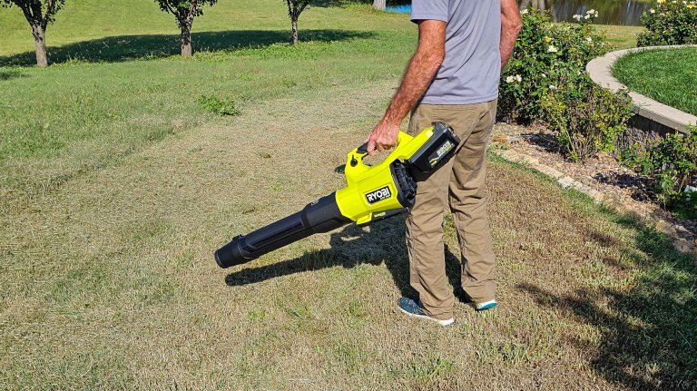 Handheld Ryobi Blower in use