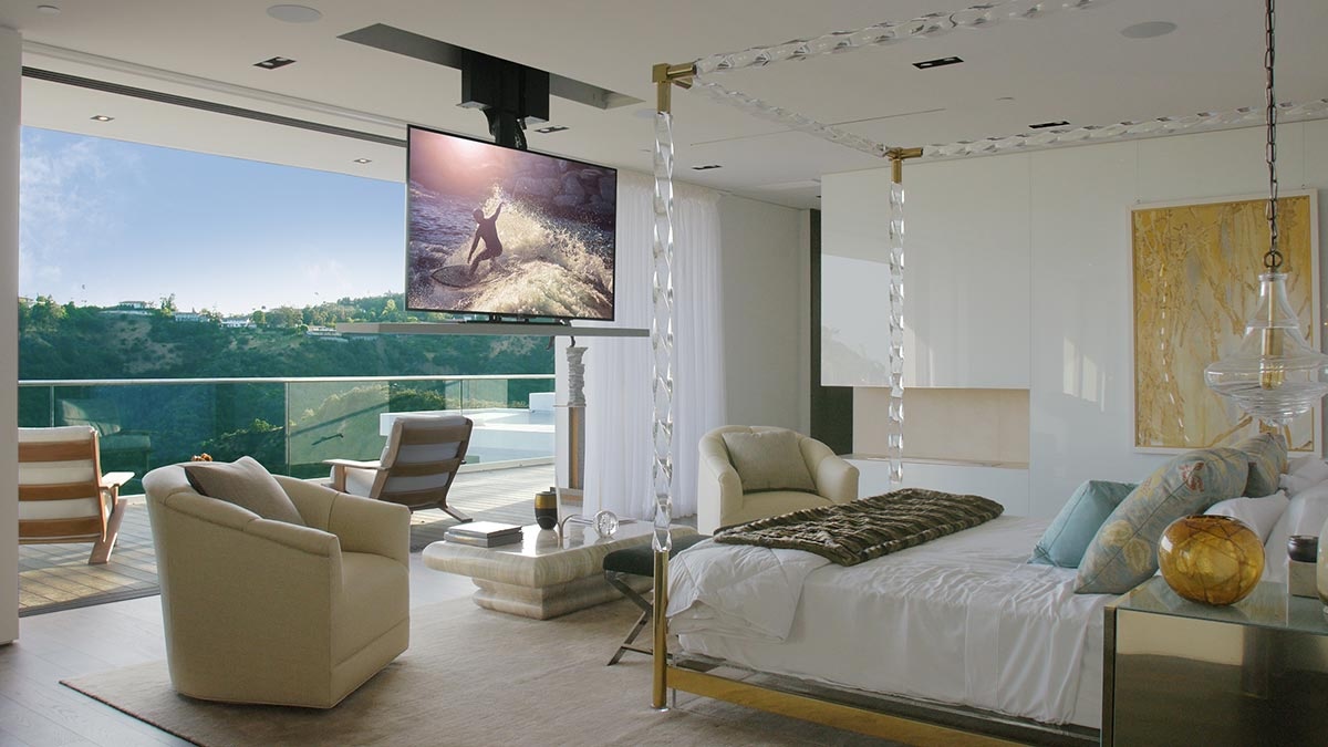 A hidden TV lift installed in a bedroom.