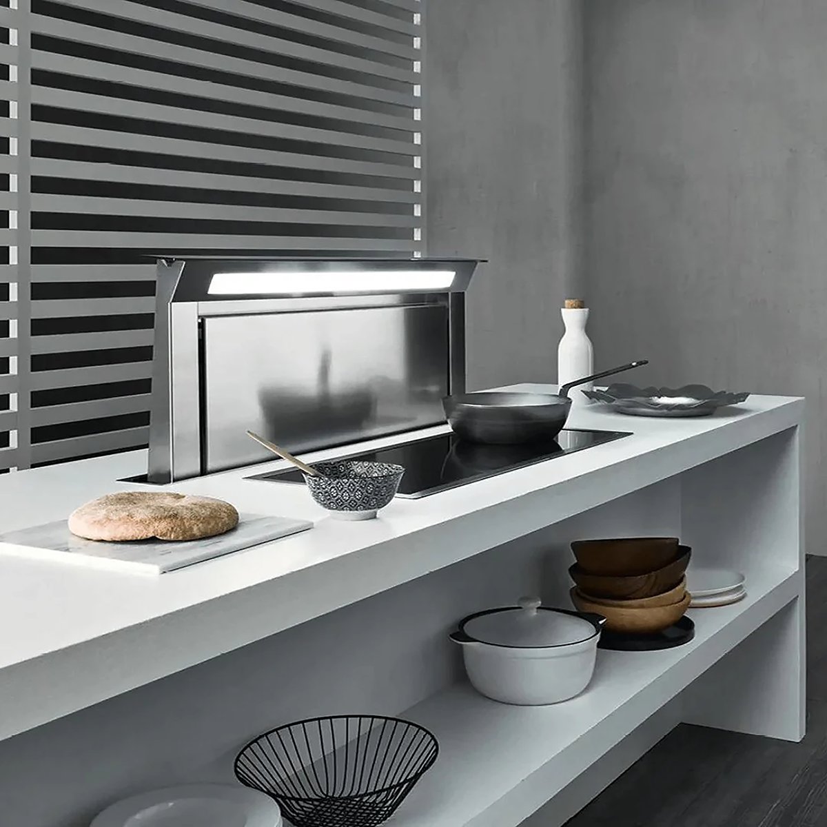 A hidden range hood on a kitchen counter with cooktop.
