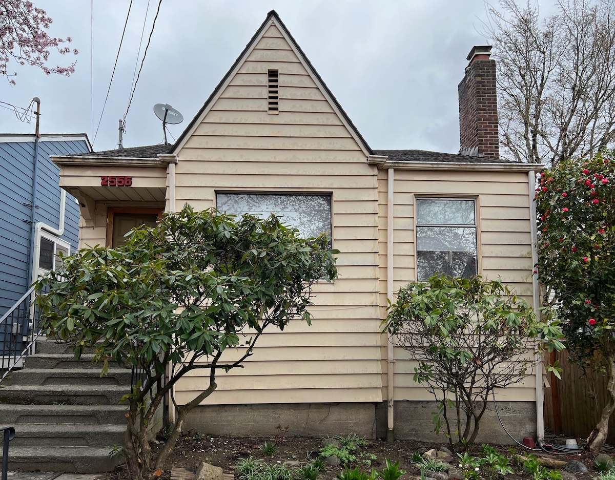A small yellow house prior to a renovation.