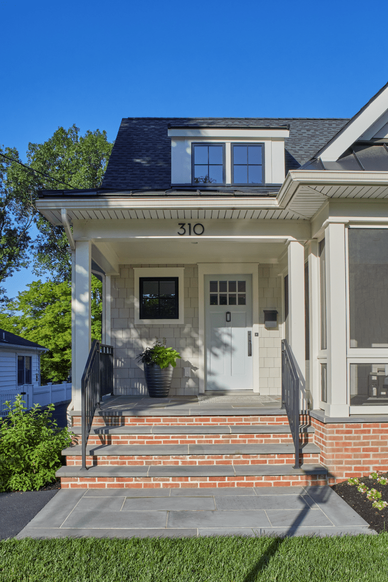A Robins eggs blue front door sitting atop red brick front steps.