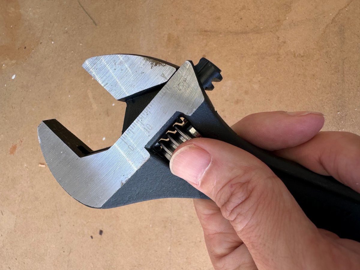 Thumb turning adjuster screw on Crescent wrench