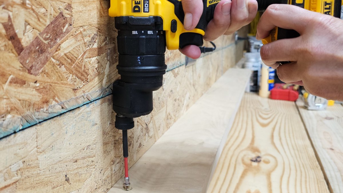 Using the offset attachment to drill right next to a wall