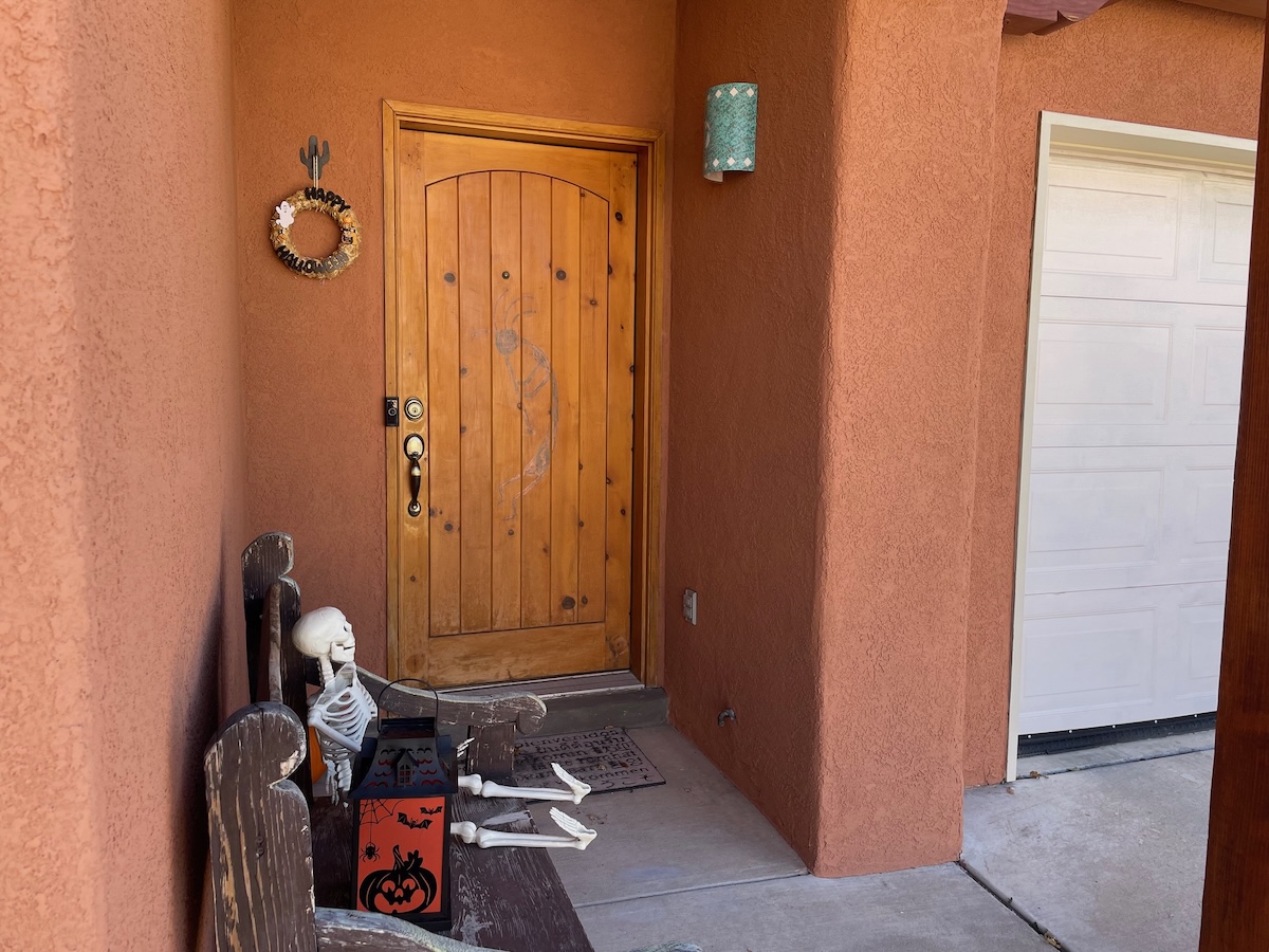 A southwestern home with repainted stucco siding in a warm terra cotta color.