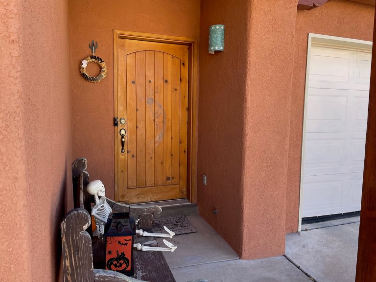 A southwestern home with repainted stucco siding in a warm terra cotta color.