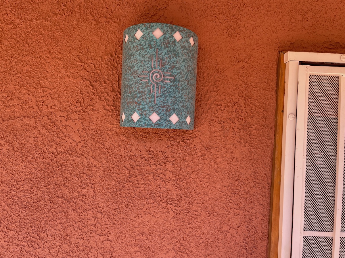 A newly painted stucco home in a terra cotta color.