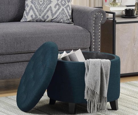 Avers Upholstered Ottoman in open revealing hidden storage in a small living room