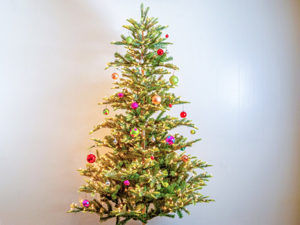 Artificial Aspen fir decorated with colorful glass ornaments