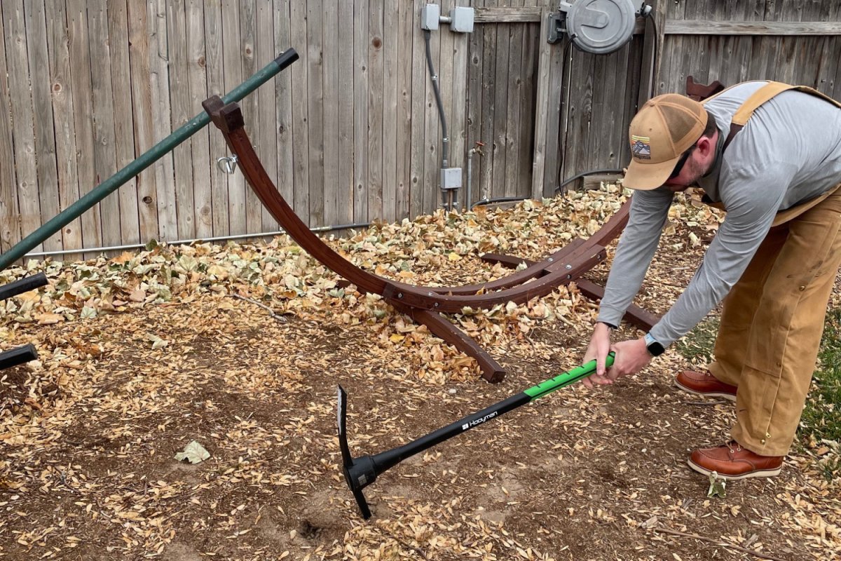 Hooyman pickaxe breaking into neglecting landscaping plot 