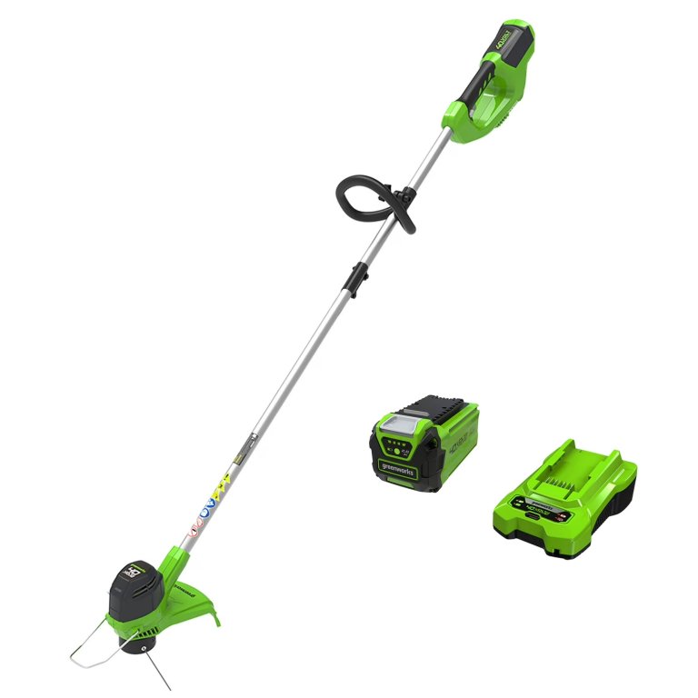 Greenworks string trimmer, battery and charger on a white background Amazon is Slashing Prices on Greenworks Tools Ahead of Black Friday—Up to 50% Off