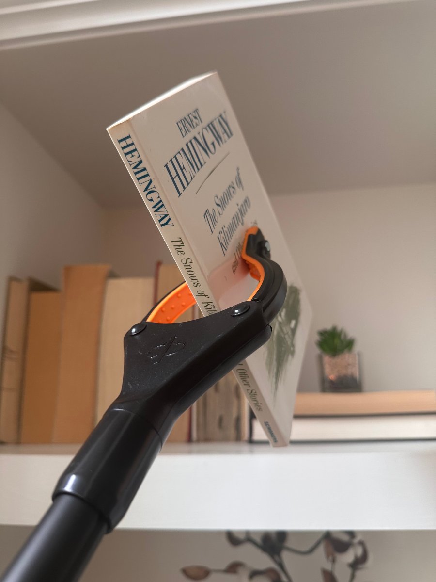 Vive grabber tool holding Hemingway book