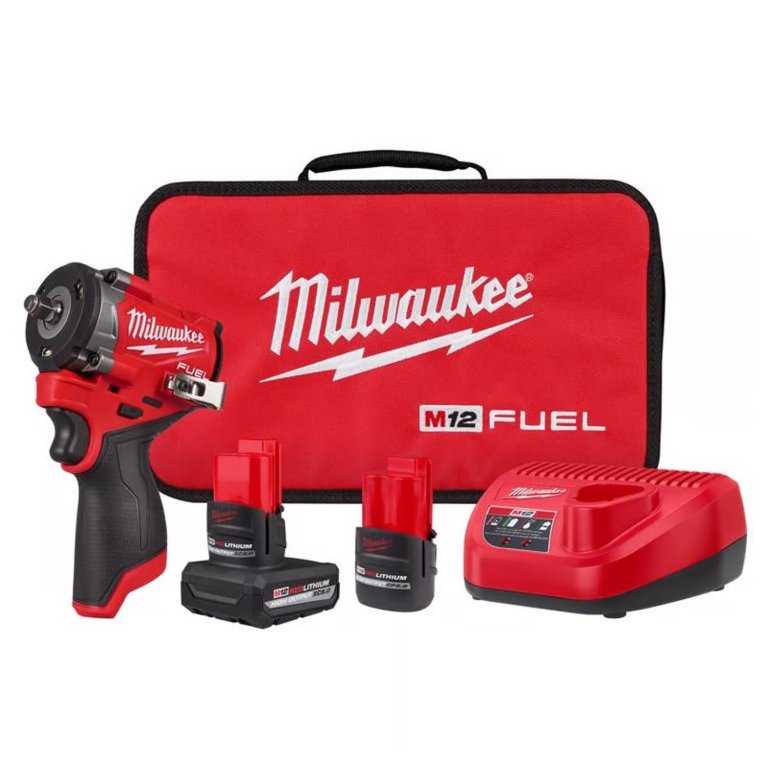 Milwaukee impact wrench with two batteries, charger, and bag on a white background