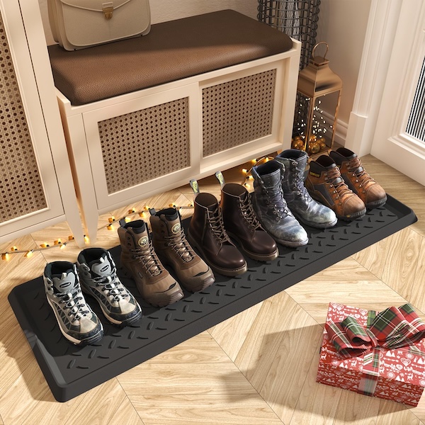 Supenuin boot tray with lots of boots and shoes lined up on it, in a mudroom.
