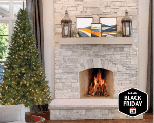 Christmas tree in front of white and gray stone fireplace