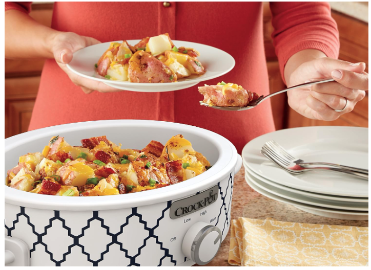 Person spooning food from Crock Pot casserole onto plate