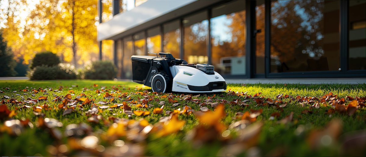 The Mammotion YUKA robot mower sweeping leaves on a suburban lawn.