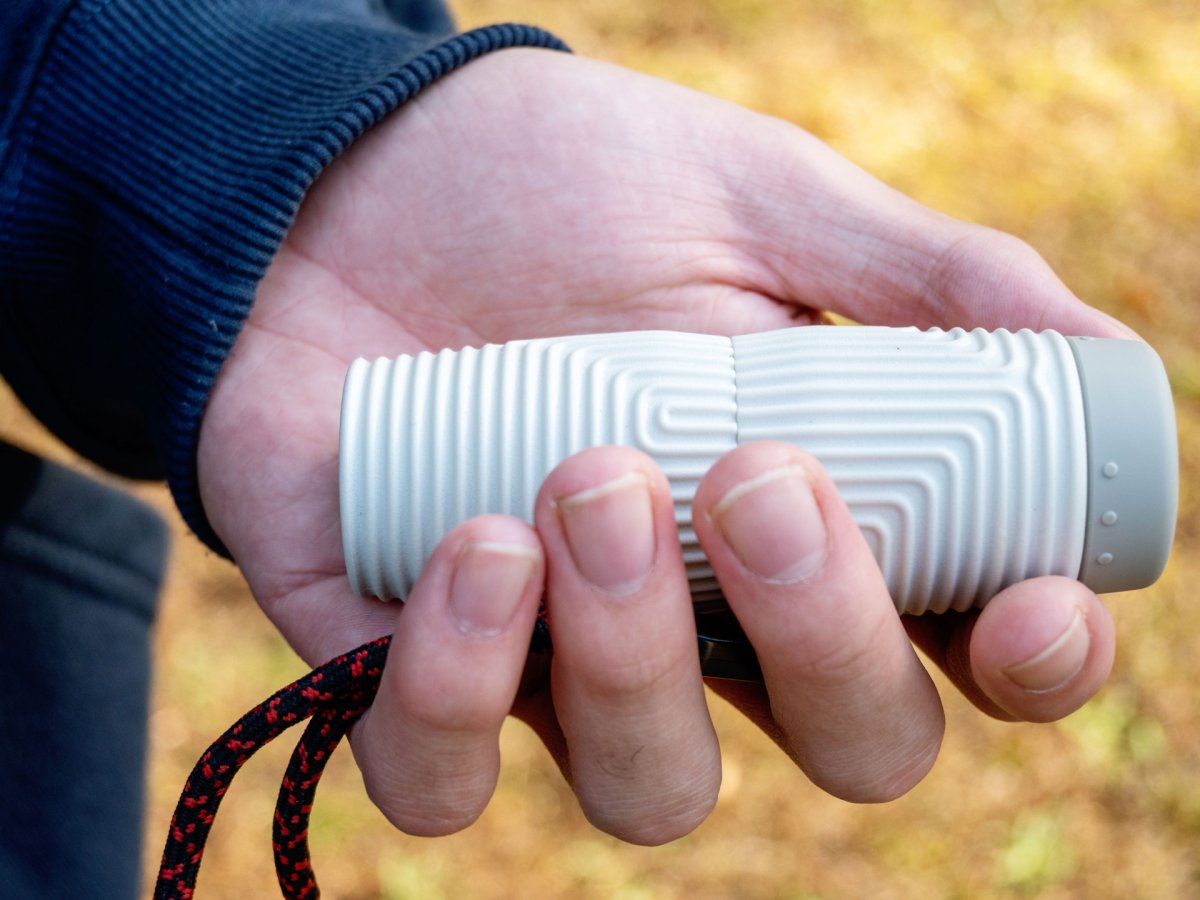 a person holding the Nocs Zero-Tube Monocular in a hand