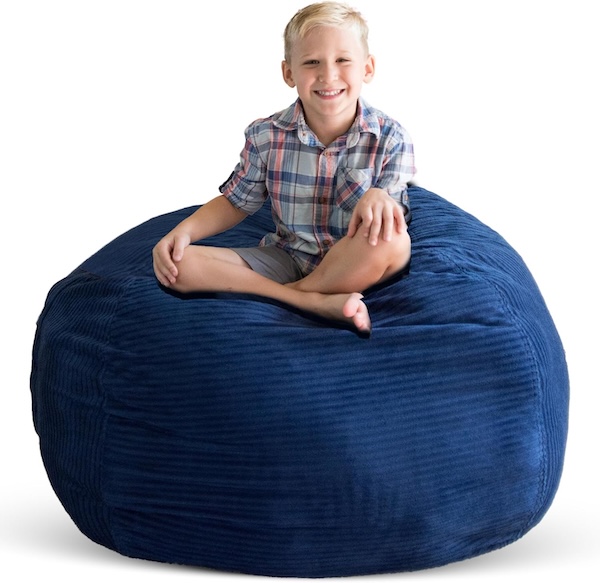 CreativeQT Bean Bag Storage chair in navy with a kid sitttng on top of it.