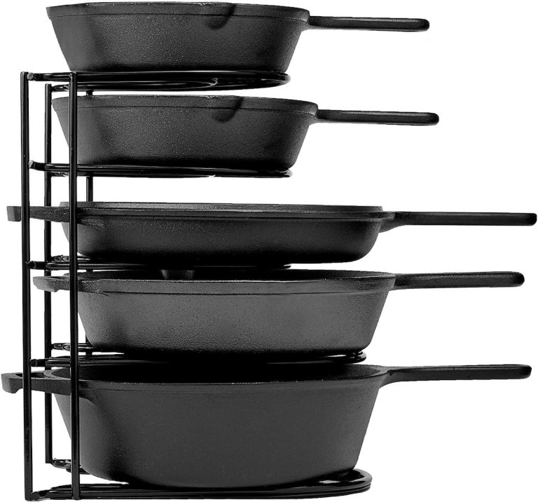 Cast iron pots and pans in a vertical organizer.