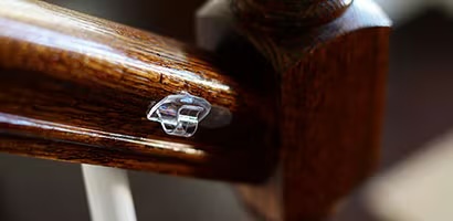 Command cord hook on a stair rail