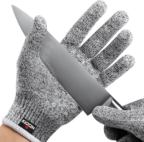 Person wearing NoCry cut-resistant gloves with a knife in their hand.