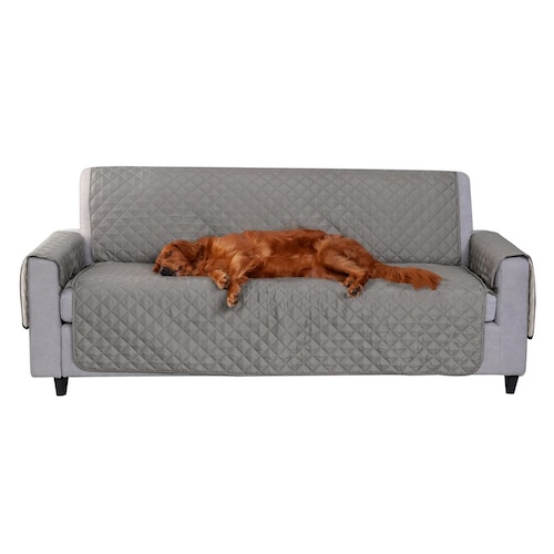 Sofa with grey FurHaven Reversible Sofa Loveseat Cover and dog sleeping.