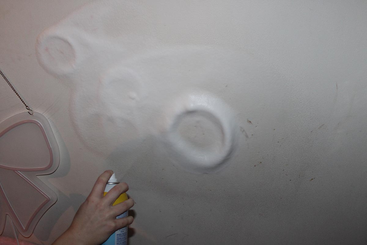 spraying zep wall cleaner on makeup stains
