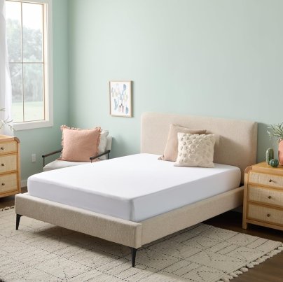 One of the best mattress protectors installed on a bed in a peaceful bedroom space