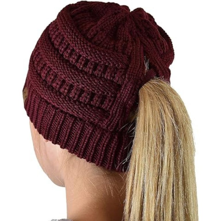 A person with their ponytail pulled through the C.C. Beanie Solid Classic Tail Winter Hat