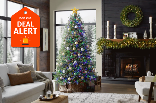 White and black living room with christmas tree and decorated mantel