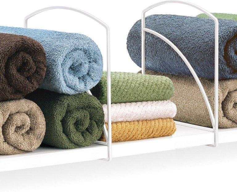 Lynk Shelf Dividers on a white shelf with towels and rags folded and organized