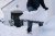 Man shoveling snow in front of house