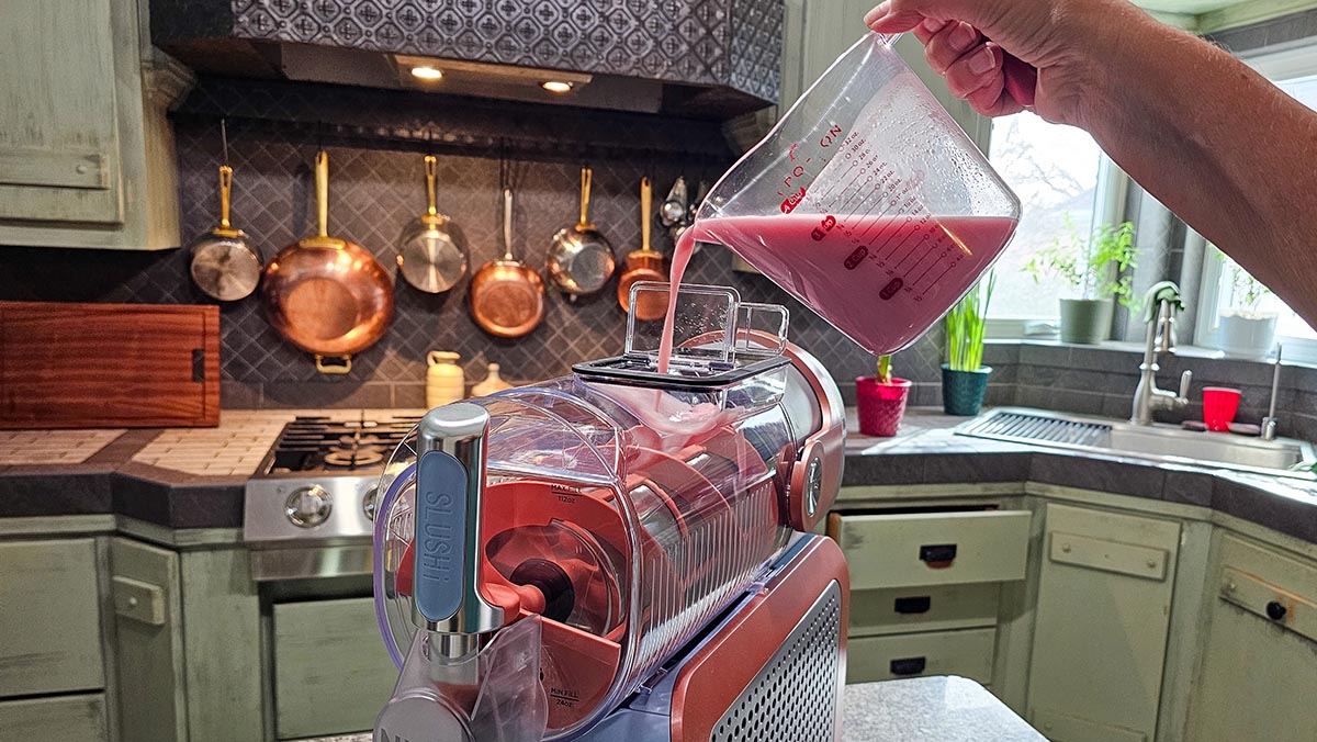 Pouring ingredients into Ninja Slushi Max