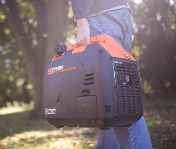 Person carrying Wen 2350W Inverter Generator