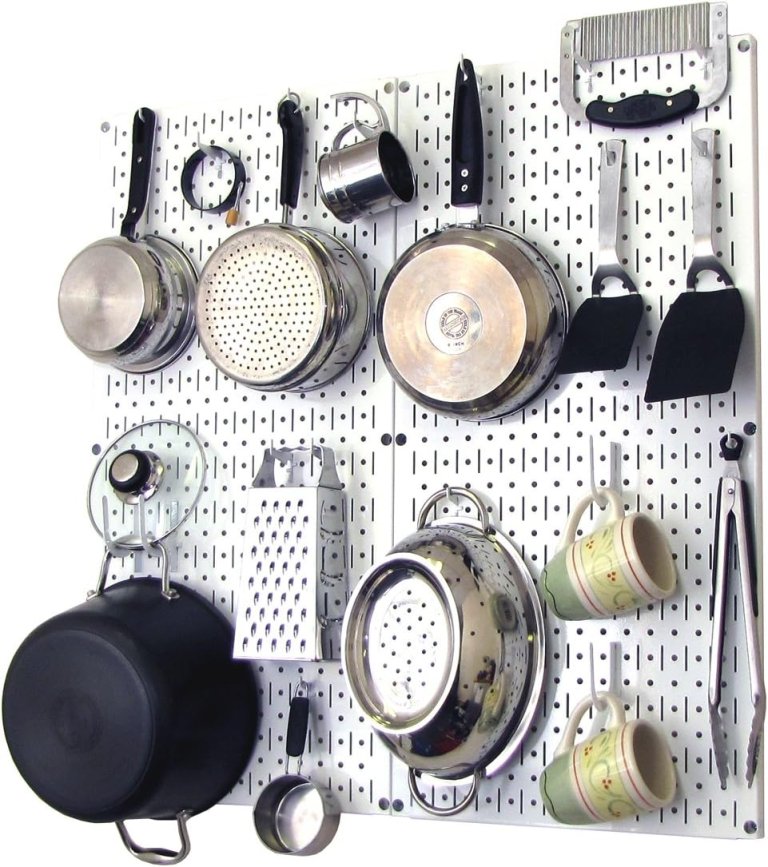 Wall Control Kitchen Pegboard Organizer with pots, pans, and utensils hanging on it