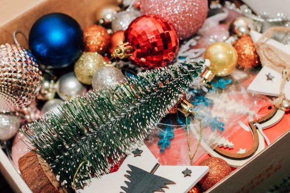 Box with Christmas toys, decor and balls.