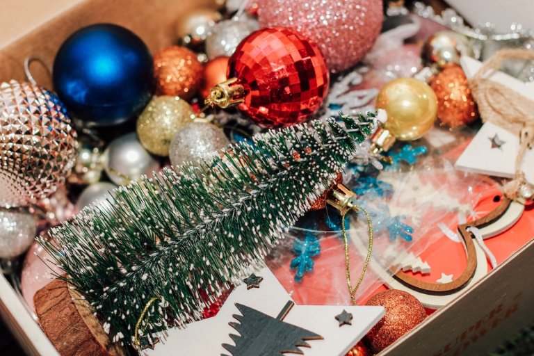 Box with Christmas toys, decor and balls.