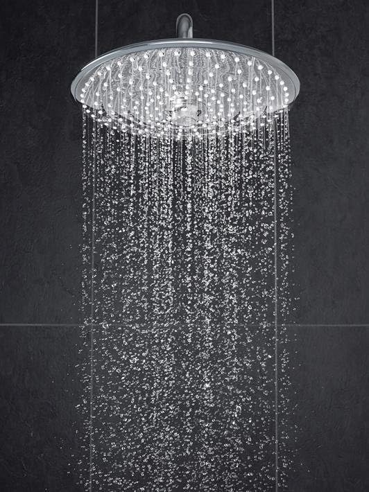 Grohe Euphoria showerhead with water coming out, on a black background.