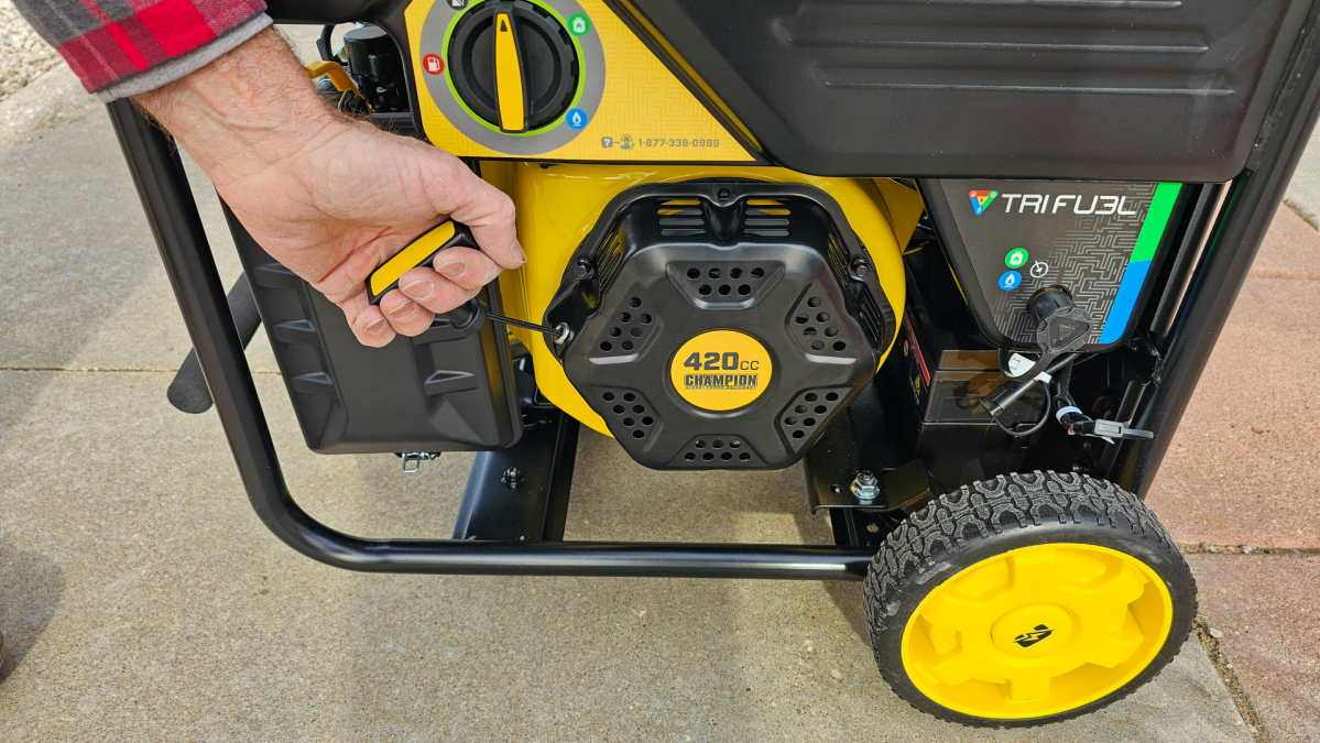 A person pulling Backup Recoil Start on the Champion 9000S