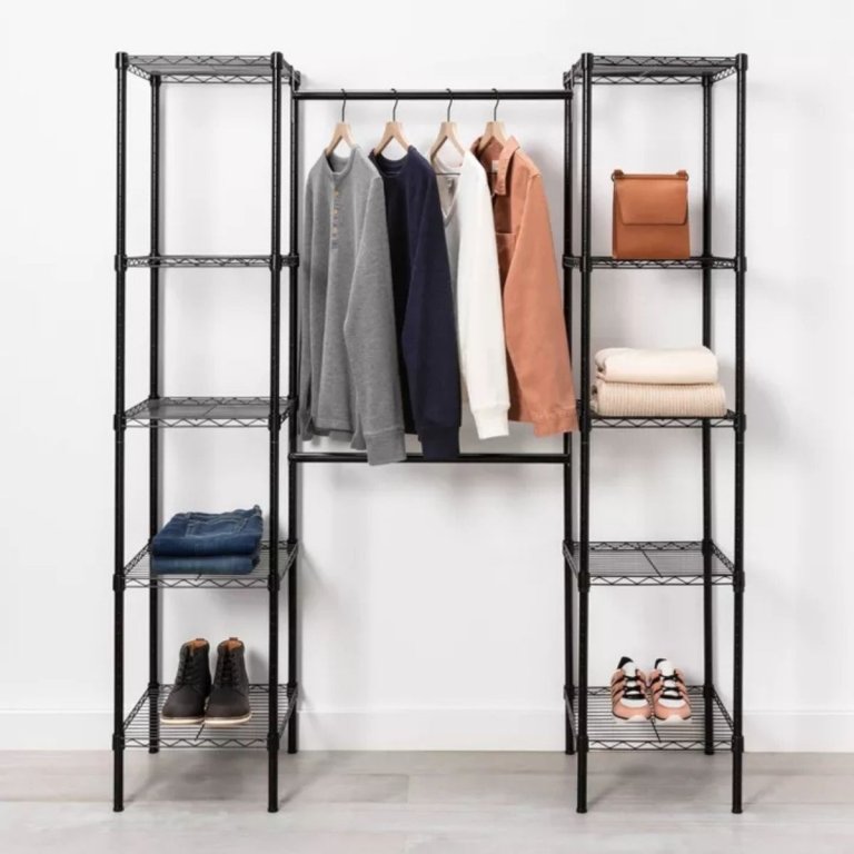 The Brightroom Wire Closet System holding a few articles of clothes while installed against a white wall